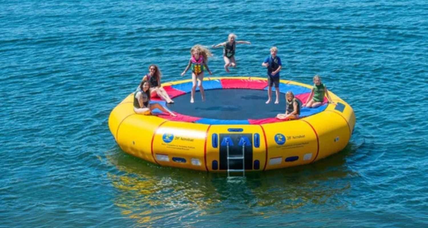 7 kids on a water trampoline jumping around - Water Trampoline vs Water Bouncer
