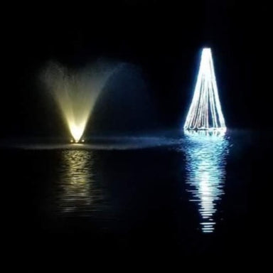 Floating Christmas Tree with White LED lights next to fountain