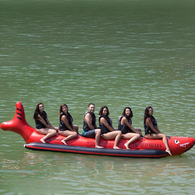 Island Hopper 6 Person Red Shark Banana Boat - Showing group of friends riding on the banana boat