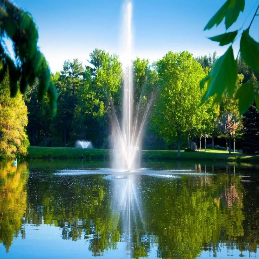 Scott Aerator Atriarch Nozzle - On Water Displaying Spray Pattern with Trees at the Background