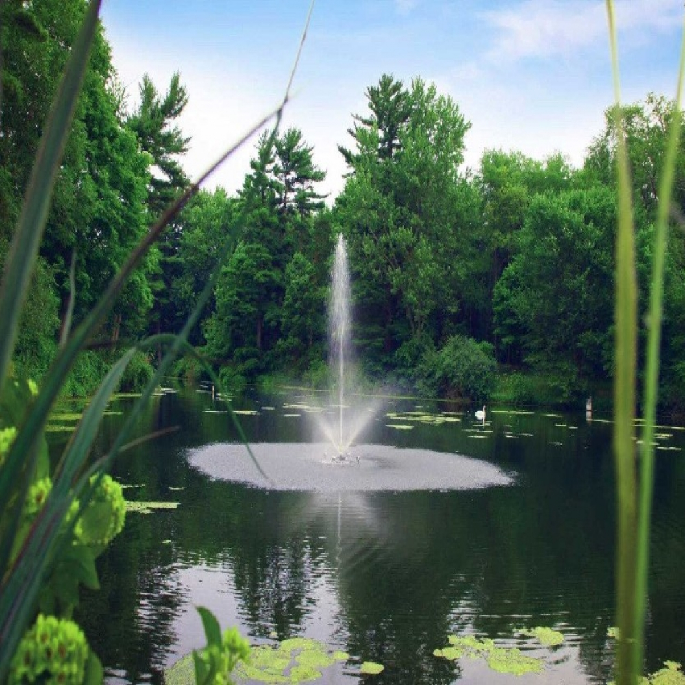 Scott Aerator Skyward Nozzle - Spray Pattern On Display with Trees at the Background