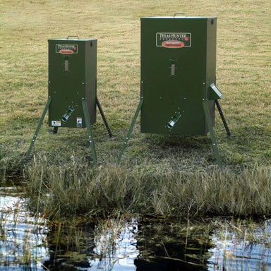 Texas Hunter Fish Feeder - showing the 75 lbs and 250 lbs units front view beside the pond