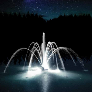 Fleur de Lis Nozzle for Aqua Control Evolution Series 1/2 HP Fountain - On Water Display at Night
