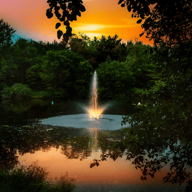 Night Glo LED Residential Fountain Lights - On Reflective Water Display with Orage Sky at the Background