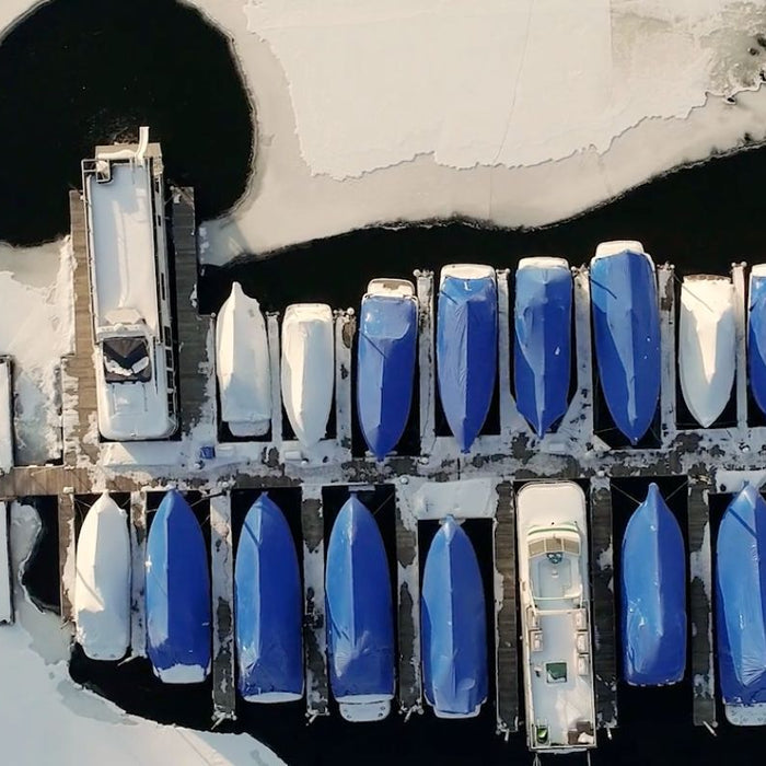 Boats at marina dock using Kasco de-icer to keep them free from all the ice around them during Winter