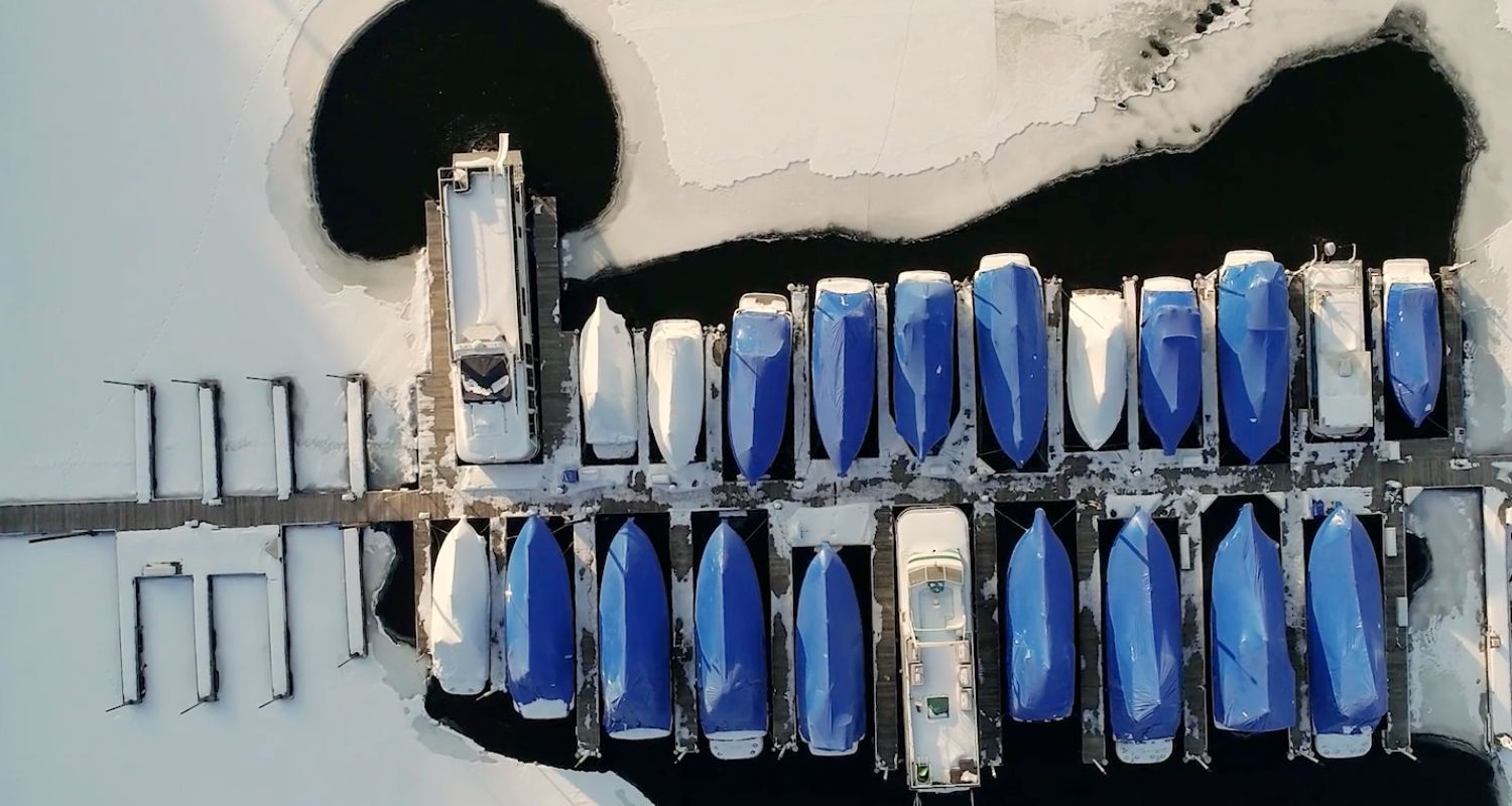 Boats at marina dock using Kasco de-icer to keep them free from all the ice around them during Winter