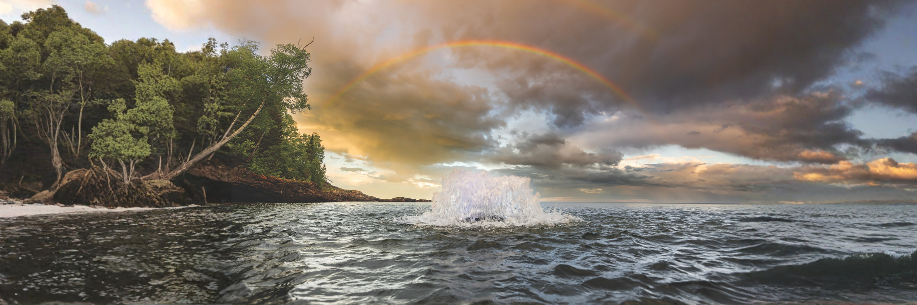 Surface Aerator in water with rainbow above it - Surface Aeration vs Bubble Aeration