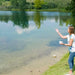 Airmax MuckAway Total Lake & Pond Muck Treatment - Woman Throwing Muck Tablets into the Lake