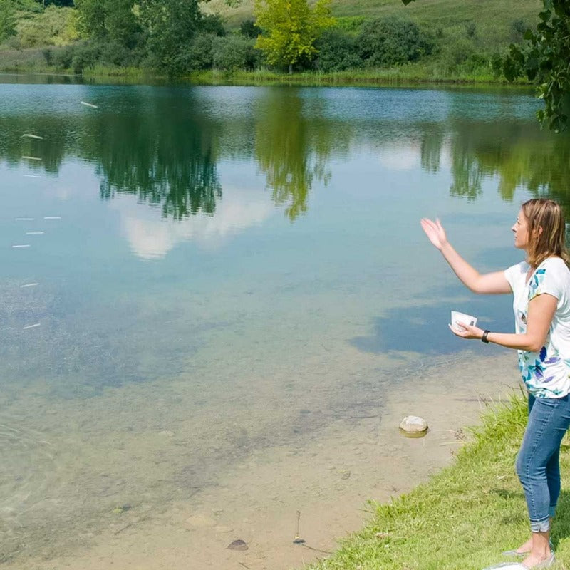 Airmax MuckAway Total Lake & Pond Muck Treatment - Woman Throwing Muck Tablets into the Lake