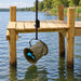 Airmax Weeds Away mounted beneath a wooden dock beside the waterfront