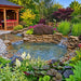 Anjon Lifeguard 45 Mil EPDM Pond Liner used in a landscaped garden pond with stone waterfalls and surrounding plants