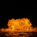 Close-up of Kasco RGB LED Lighting creating amber illumination on fountain water splash at night
