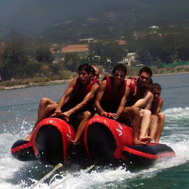 Island Hopper 10 Person Red Shark Banana Boat - Showing the group of males enjoying the ride on the banana boat