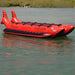 Island Hopper 10 Person Red Shark Banana Boat - Showing the side view of the banana boat on the water 