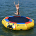 Island Hopper 13' Bounce and Splash Water Bouncer - Showing a girl jumping on the yellow water bouncer