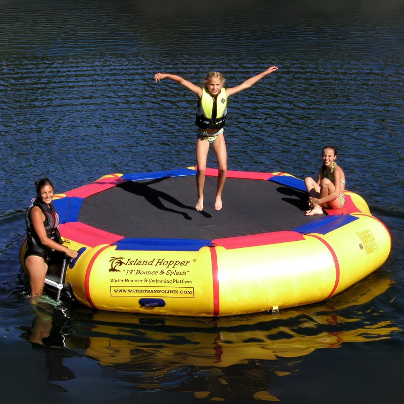 Island Hopper 13' Bounce and Splash Water Bouncer - Showing three girls playing around the water bouncer