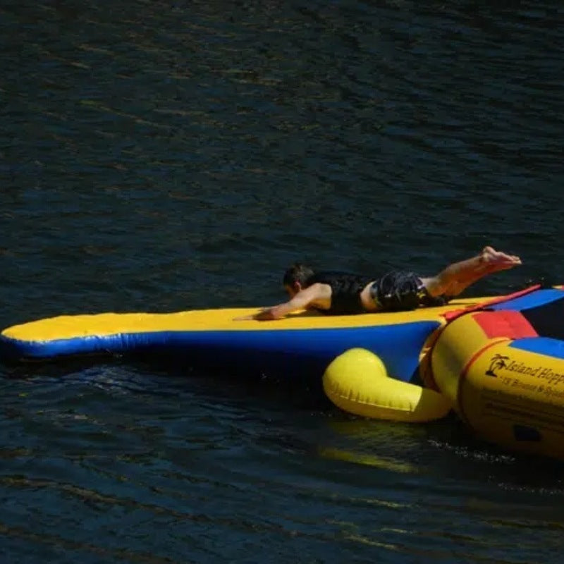 Island Hopper 15' Gator Monster Water Trampoline Park - Shown with a child sliding on the head of the gator water trampoline