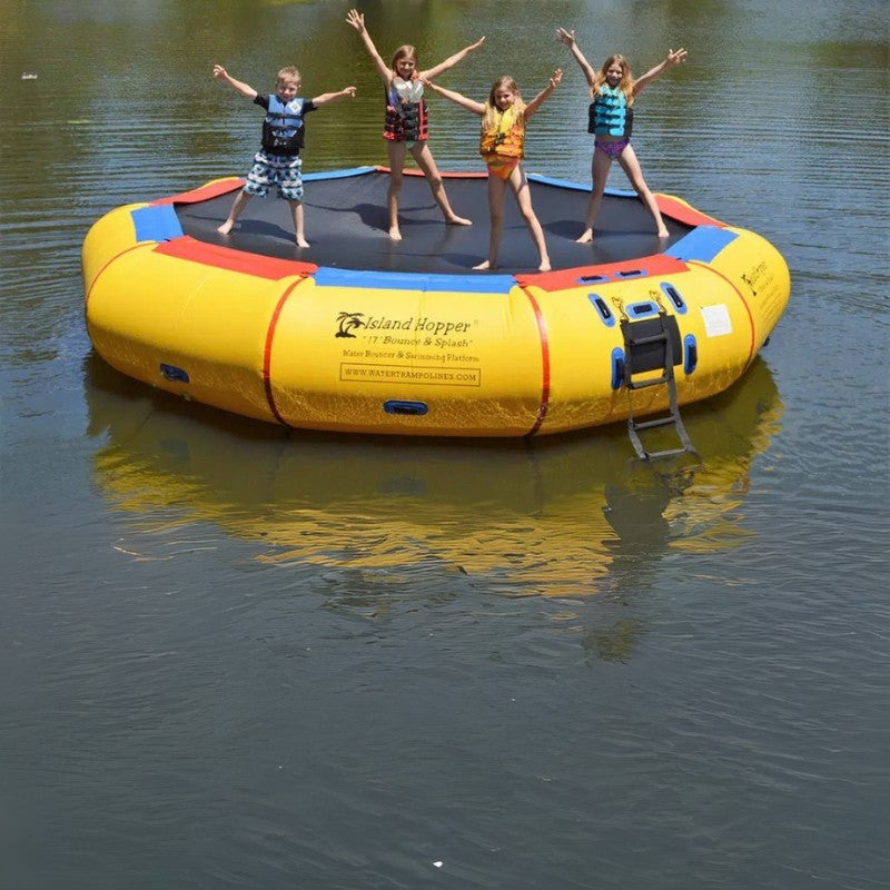 Island Hopper 17' Bounce and Splash Water Bouncer - Showing a group of kids raising their hands on the water bouncer