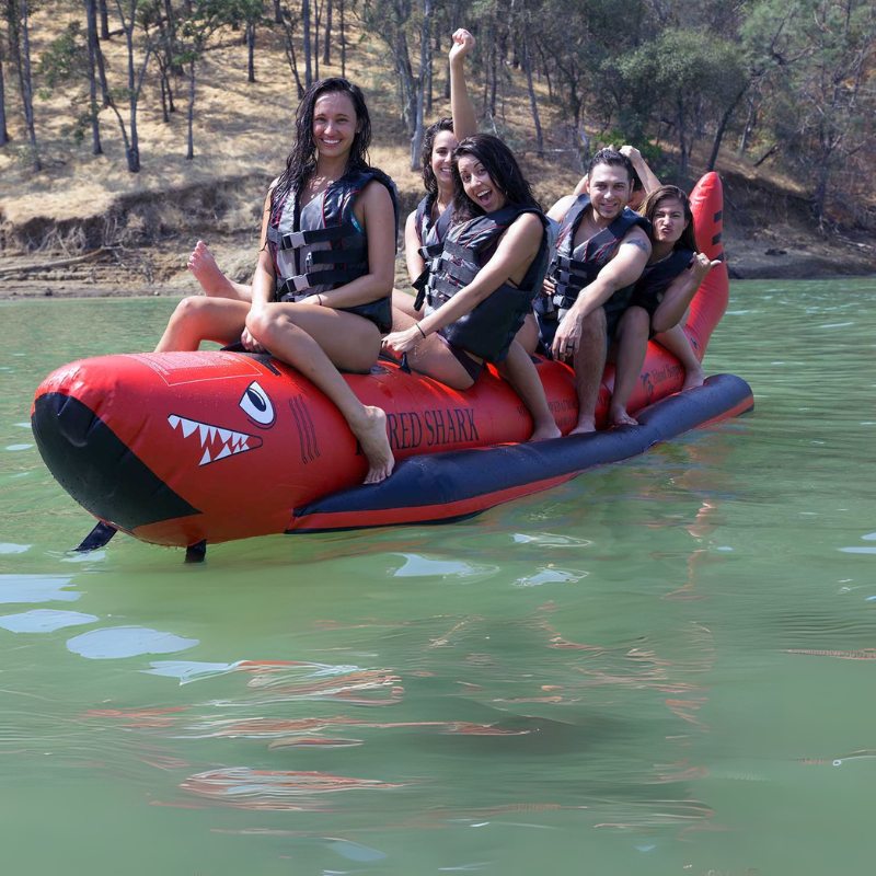 Island Hopper 6 Person Red Shark Banana Boat - Showing group of friends having fun while riding on the boat