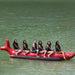 Island Hopper 6 Person Red Shark Banana Boat - Showing group of friends riding on the banana boat