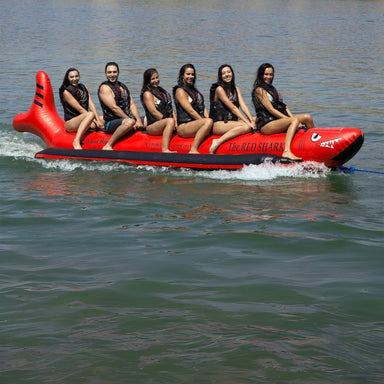 Island Hopper 6 Person Red Shark Banana Boat - Showing group of friends smiling while riding on the banana boat