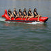 Island Hopper 6 Person Red Shark Banana Boat - Showing group of friends smiling while riding on the banana boat