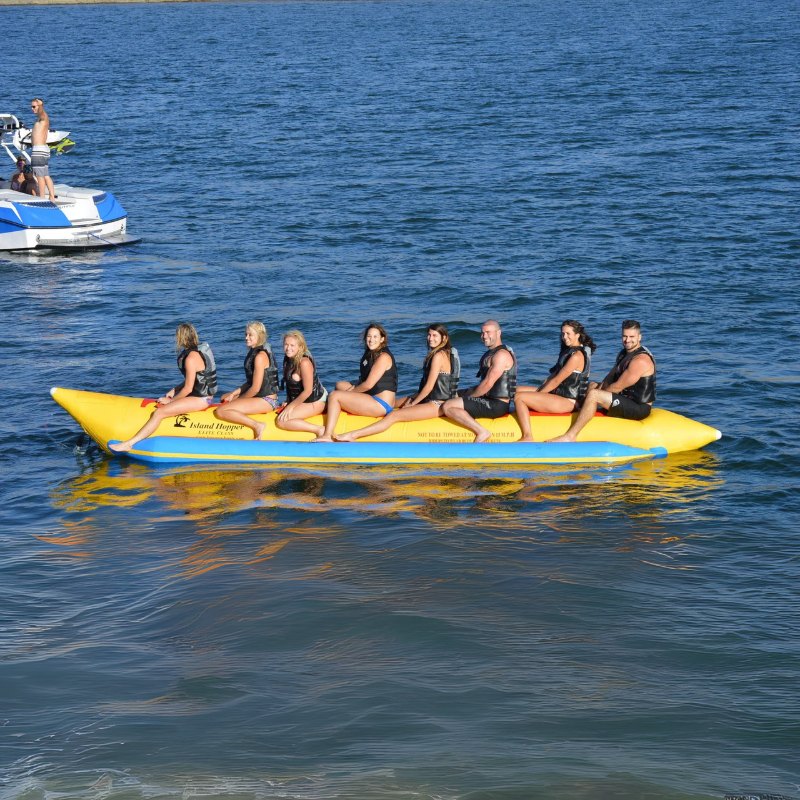 Island Hopper Elite Class 8 Person Banana Boat Tube - Showing group of friends riding on the banana boat