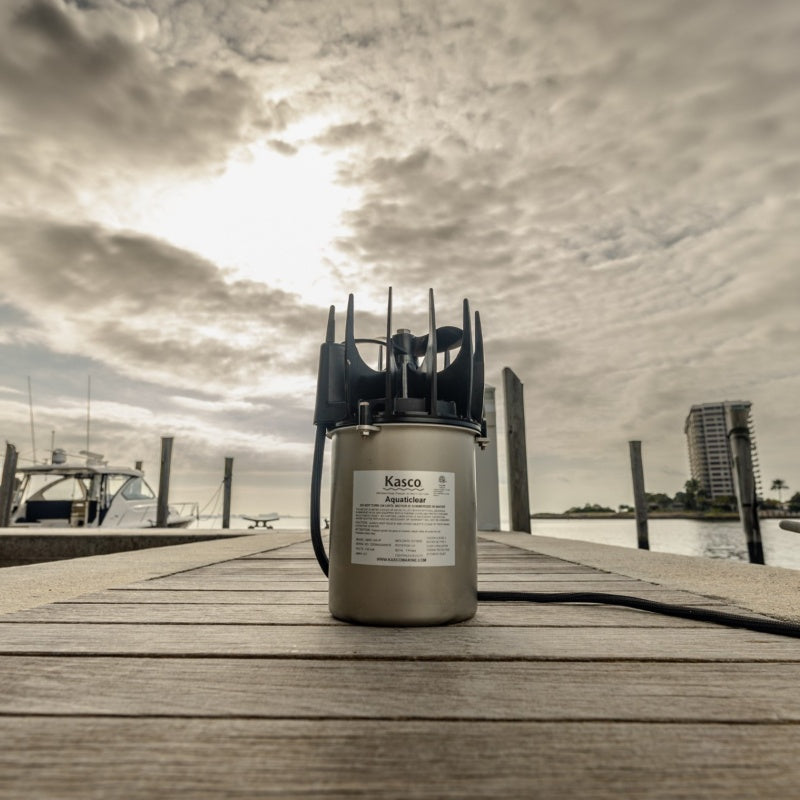 Kasco AquatiClear unit displayed on dock with marina and waterfront background