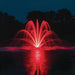 Kasco Composite LED Light Kit illuminating fountain with vibrant red lighting at night over reflective pond surface
