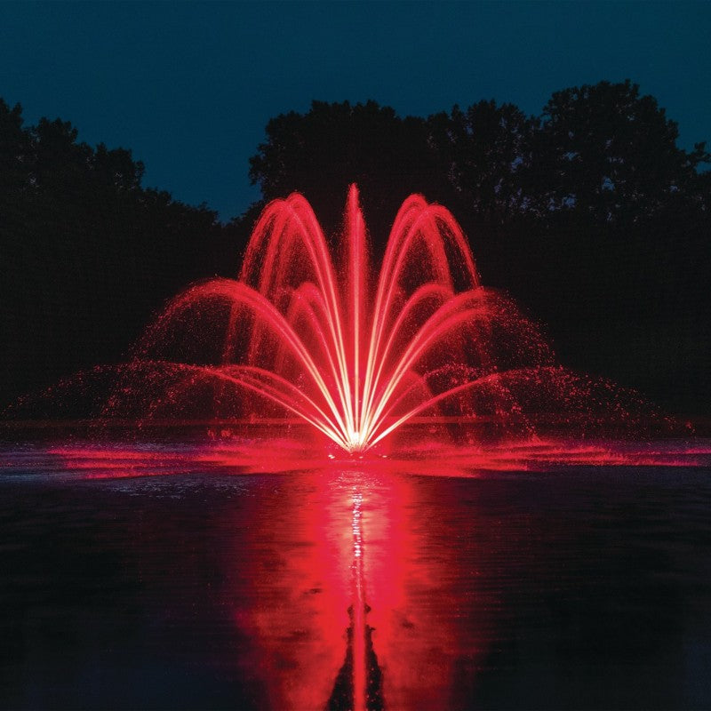 Kasco Composite LED Light Kit illuminating fountain with vibrant red lighting at night over reflective pond surface