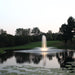 Kasco Composite LED Light Kit lighting a vertical fountain display in a calm pond during dusk
