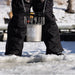 Kasco De-Icer being lowered through an ice hole by a person standing on frozen water during winter installation