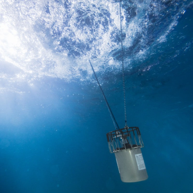 Kasco De-Icer operating underwater beneath ice surface with visible water circulation and suspension cable