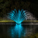 Kasco Fern Fountain with teal LED lighting display on pond at night
