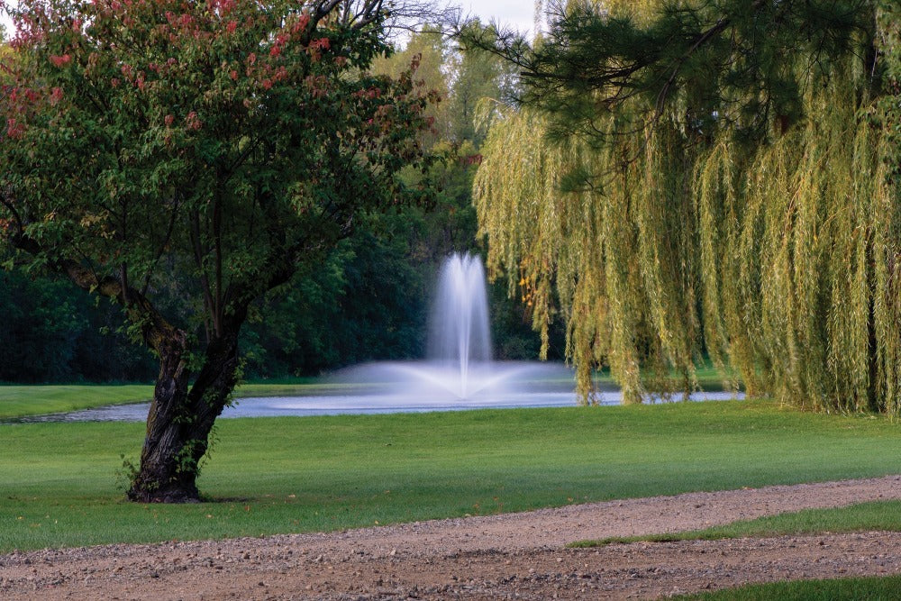 Kasco J Series Floating Fountain On Water with Trees at the Background
