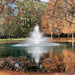 Kasco J Series Fountain with Balsam nozzle spray pattern creating a tiered water display in a tree-lined pond during the day