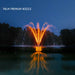 Kasco J Series Fountain with Palm Premium Nozzle illuminated at night with orange lighting