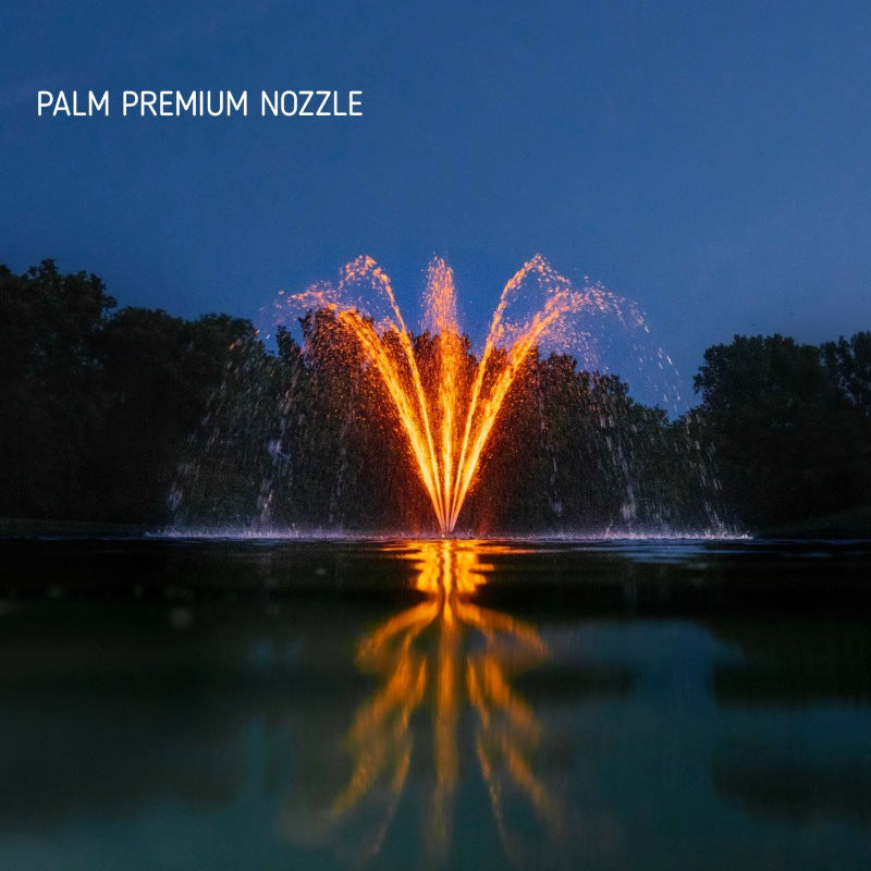Kasco J Series Fountain with Palm Premium Nozzle illuminated at night with orange lighting