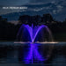 Kasco J Series Fountain with Palm Premium Nozzle illuminated at night with purple lighting