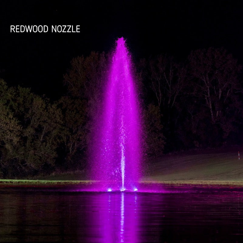 Kasco J Series Fountain with Redwood Nozzle illuminated at night with purple lighting on golf course pond