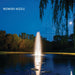 Kasco J Series Fountain with Redwood Nozzle illuminated at night with white lighting under moonlit sky