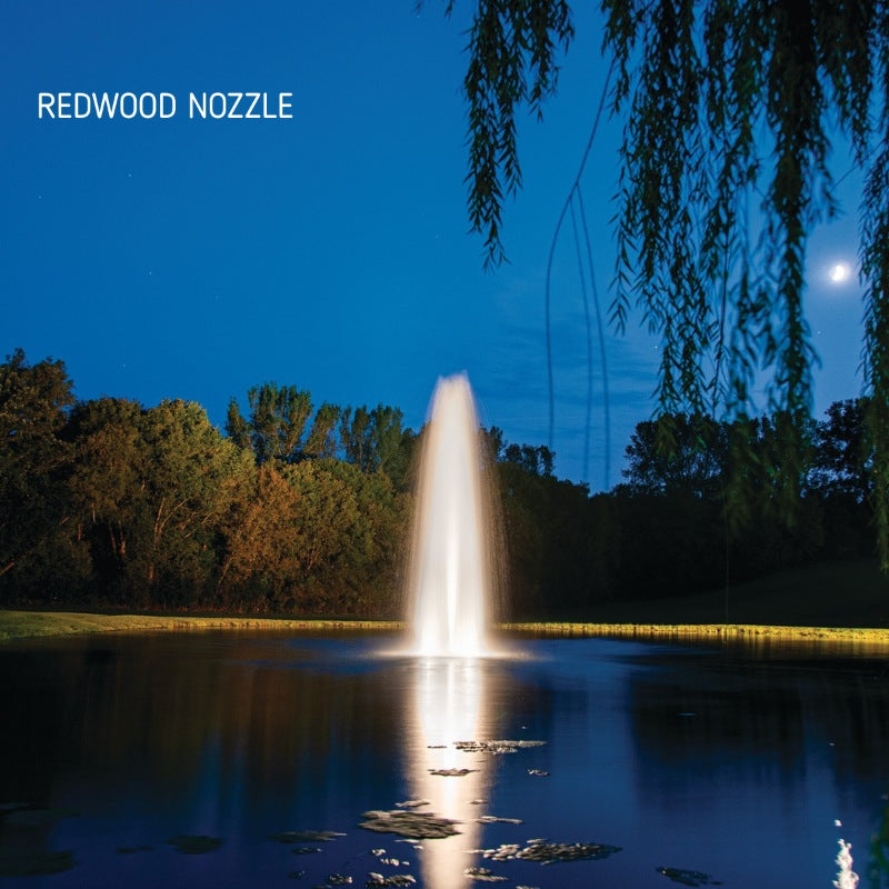 Kasco J Series Fountain with Redwood Nozzle illuminated at night with white lighting under moonlit sky