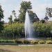 Kasco J Series Fountain with Redwood Nozzle spray pattern in daytime residential pond setting