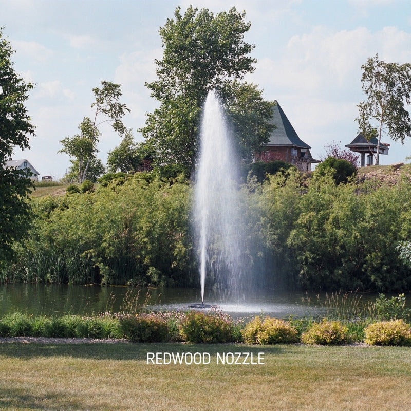 Kasco J Series Fountain with Redwood Nozzle spray pattern in daytime residential pond setting