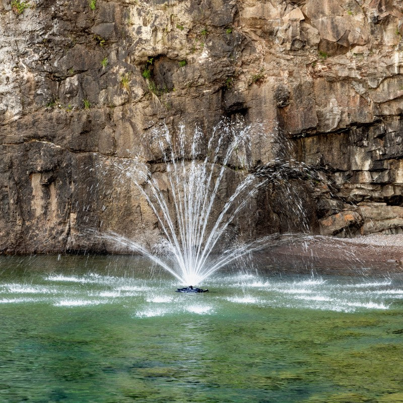 Kasco Mighty Oak Fountain Masterpiece Bundle spray pattern in daytime rocky cliff waterway setting