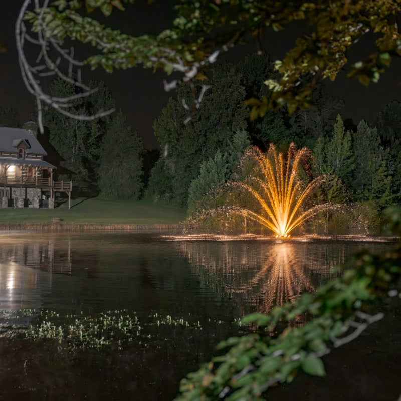 Kasco Mighty Oak Premium Fountain Nozzle with orange LED lighting at night