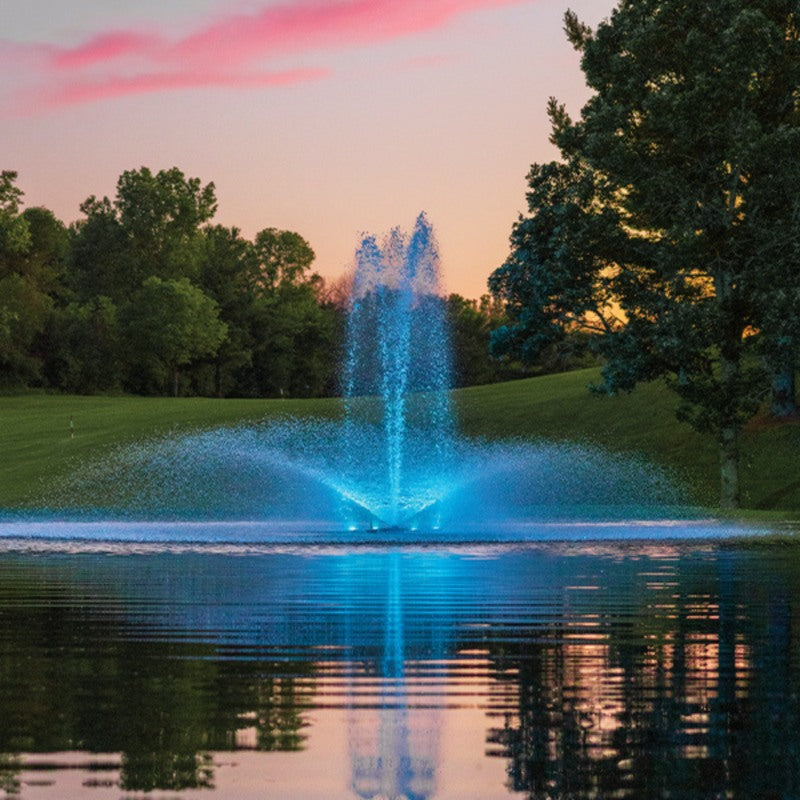 Kasco RGBW LED Lighting - RGBW18 LED Lighting System illuminating a pond fountain in blue during sunset