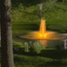 Kasco RGBW LED Lighting - RGBW18 LED Lighting System illuminating a pond fountain in warm golden light at night