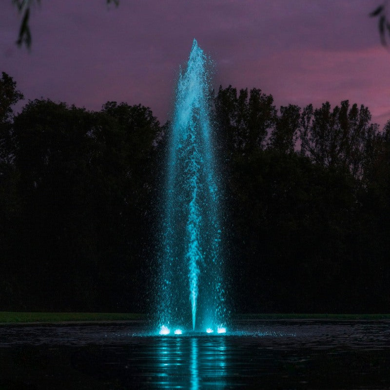 Kasco RGBW LED Lighting - RGBW18 LED Lighting System illuminating a tall vertical pond fountain in teal during dusk