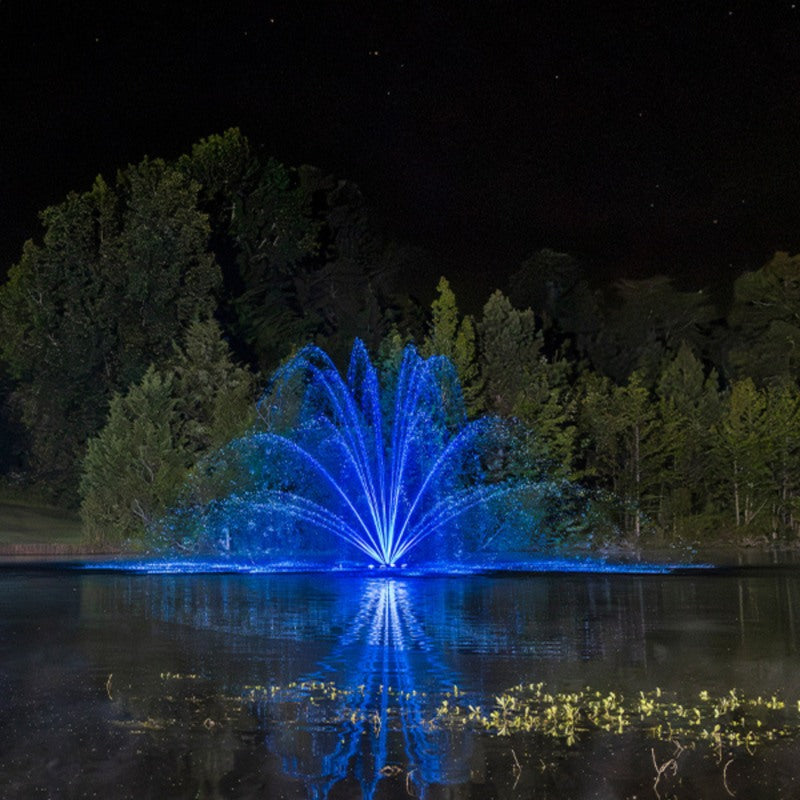 Kasco RGBW LED Lighting - RGBW18 LED Lighting System illuminating a wide-pattern fountain in blue at night